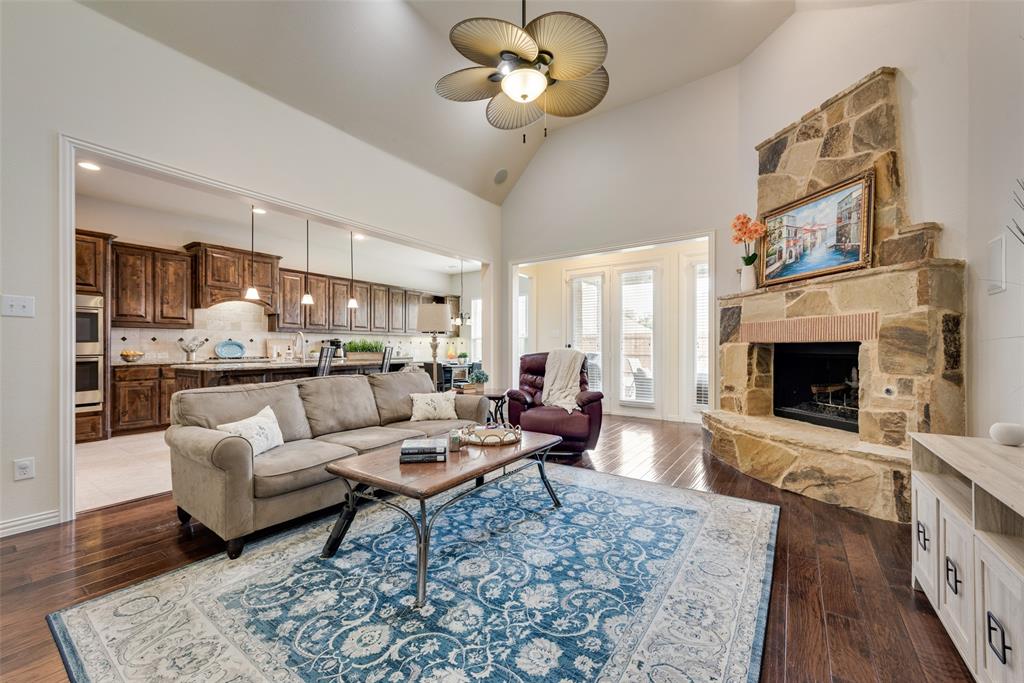 a living room with furniture a fireplace and a chandelier