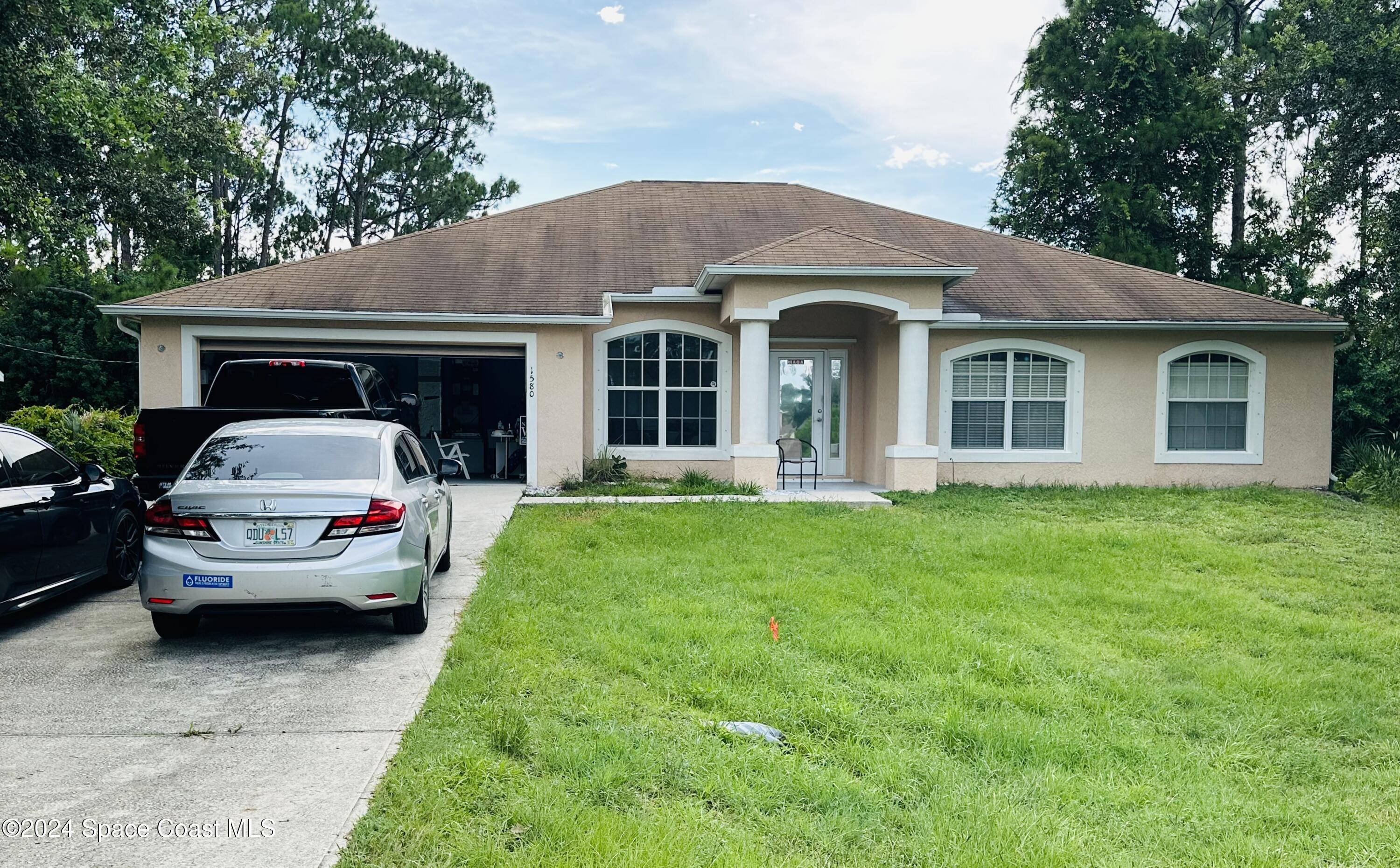 a view of a car parked in front of house