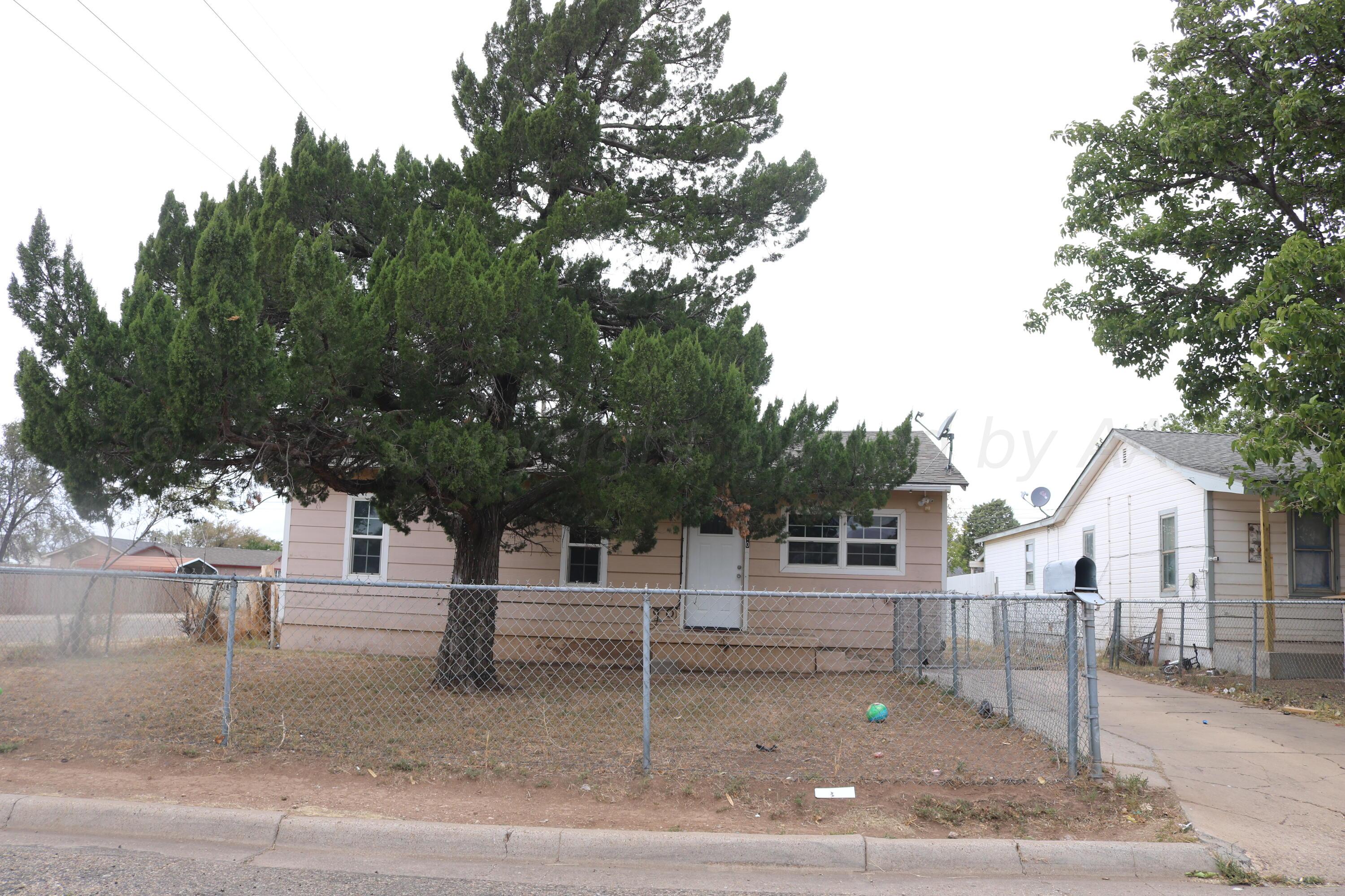 a view of street along with house and trees