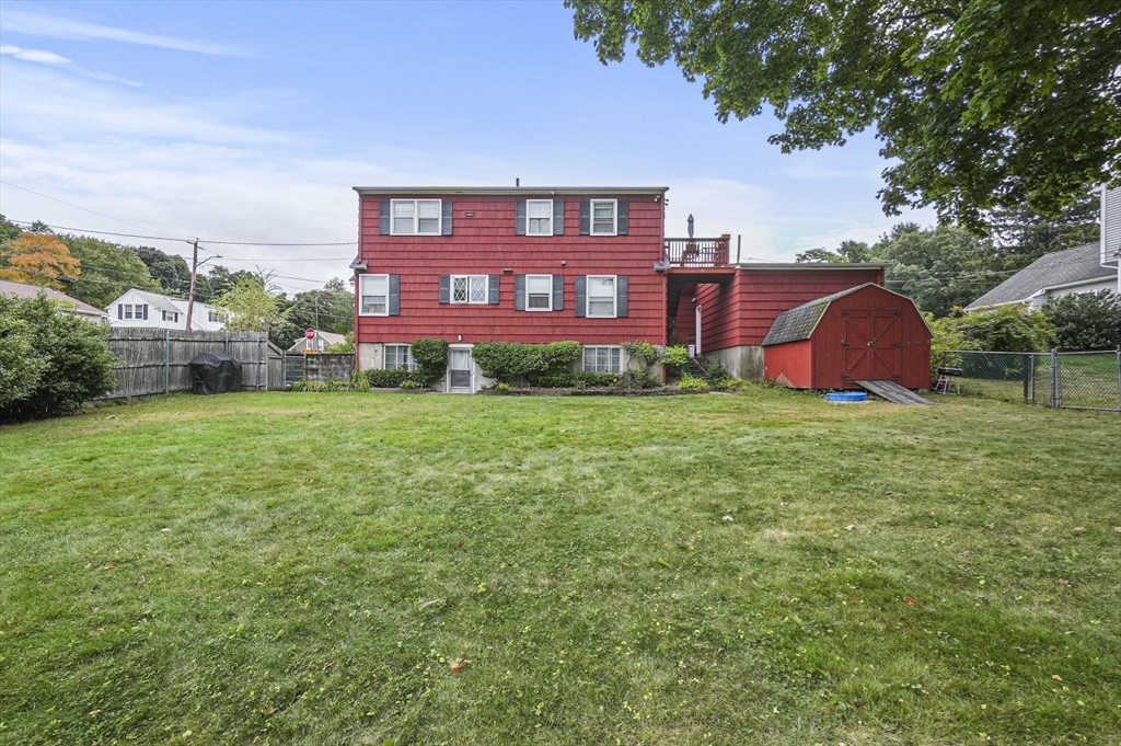 a view of a big house with a big yard and potted plants