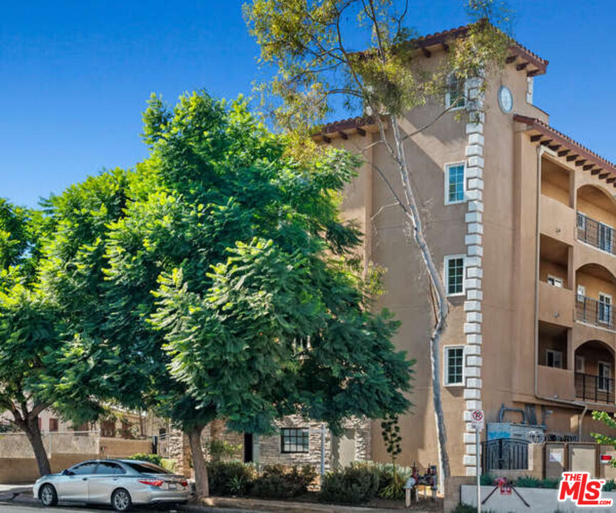 a front view of a building with trees