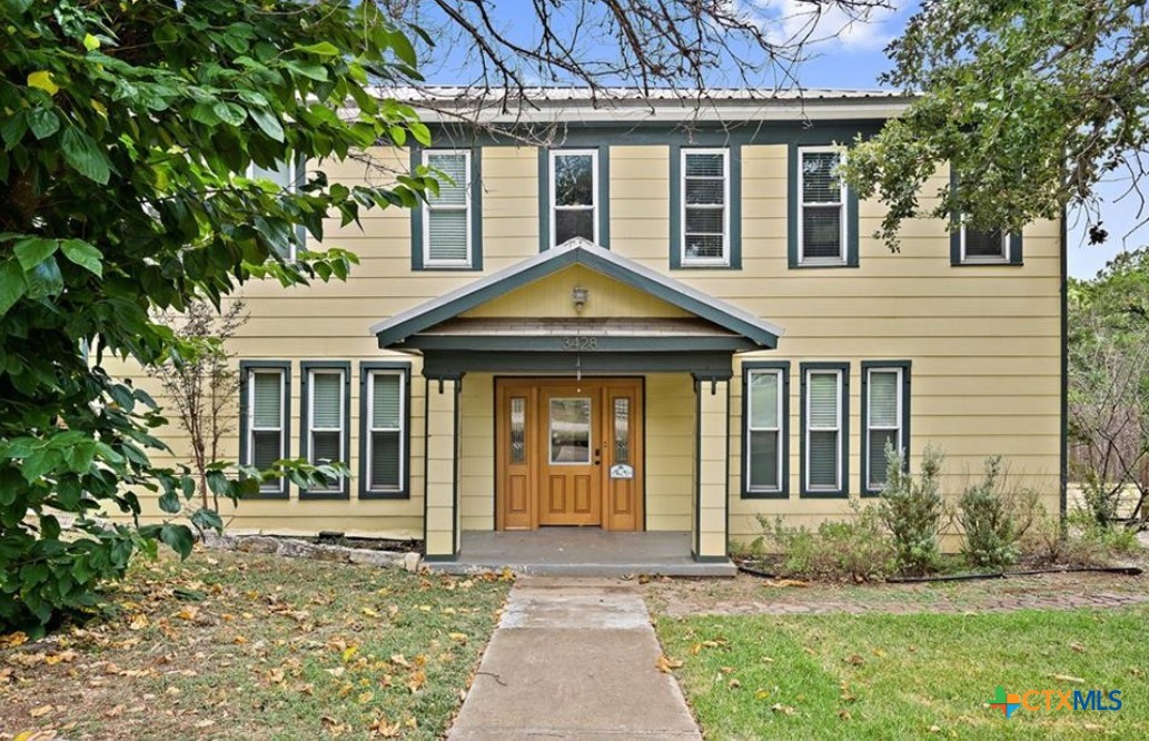 front view of a house with a yard