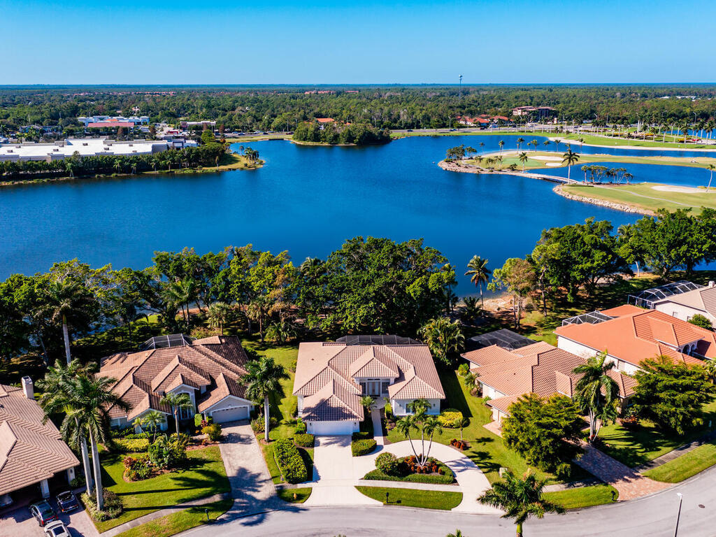 an aerial view of residential houses with outdoor space and lake view