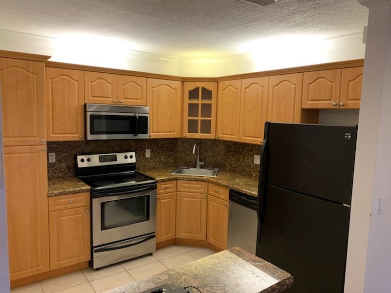 a kitchen with a refrigerator stove and microwave