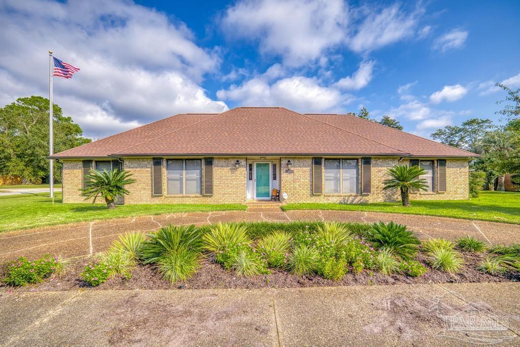 a front view of a house with a garden