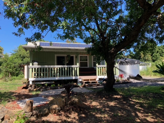 a view of a house with backyard sitting area and garden