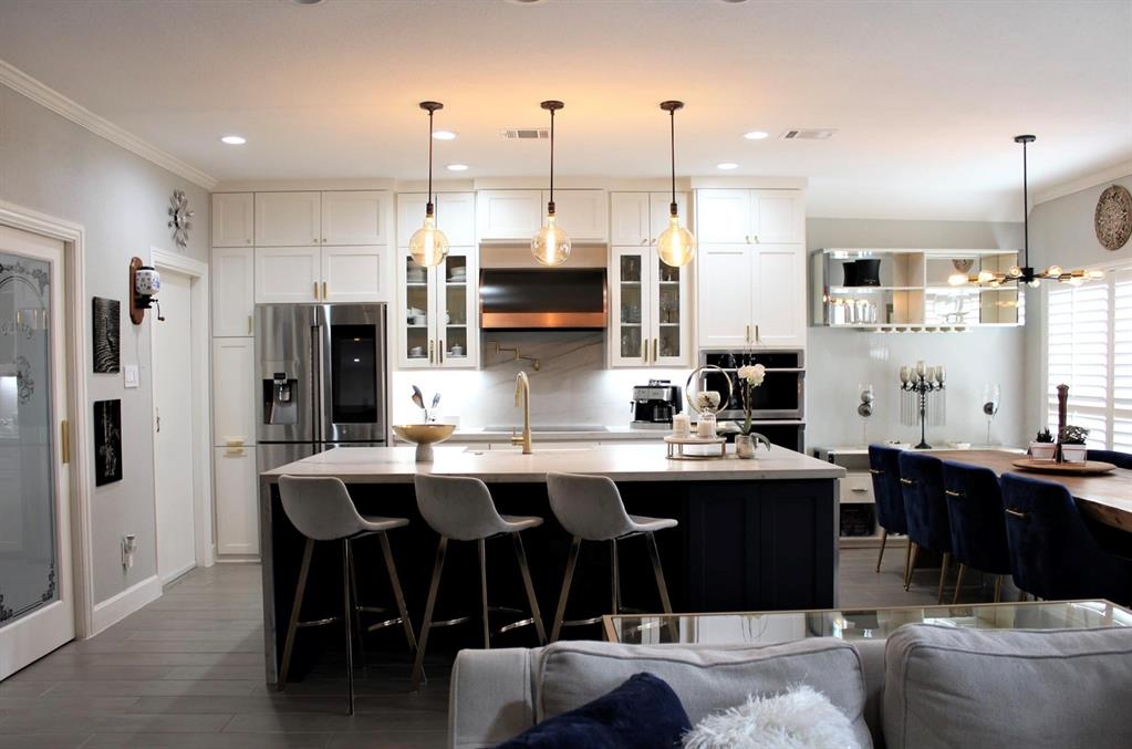 a large kitchen with a table and chairs