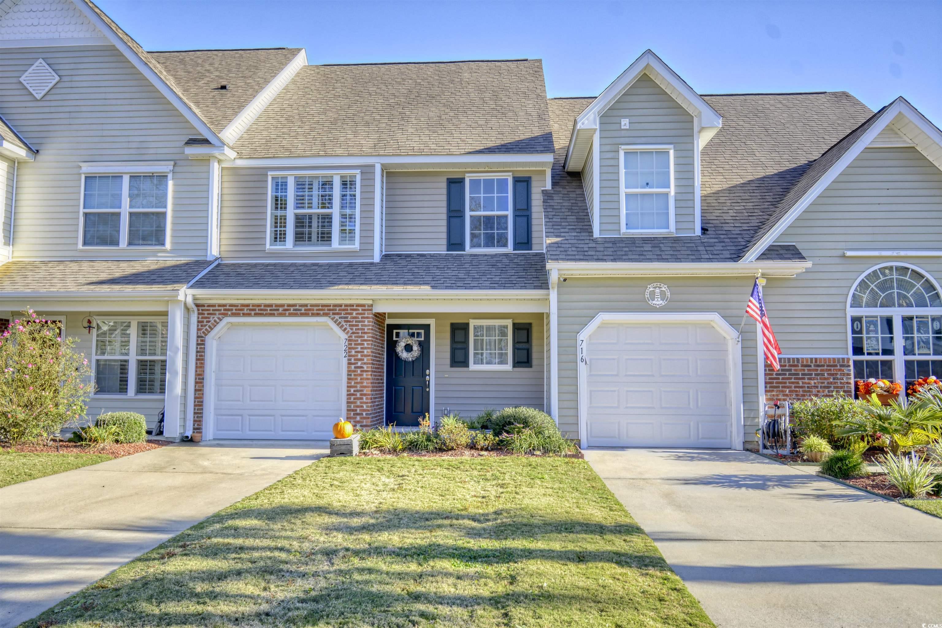 View of front of property with a garage and a fron