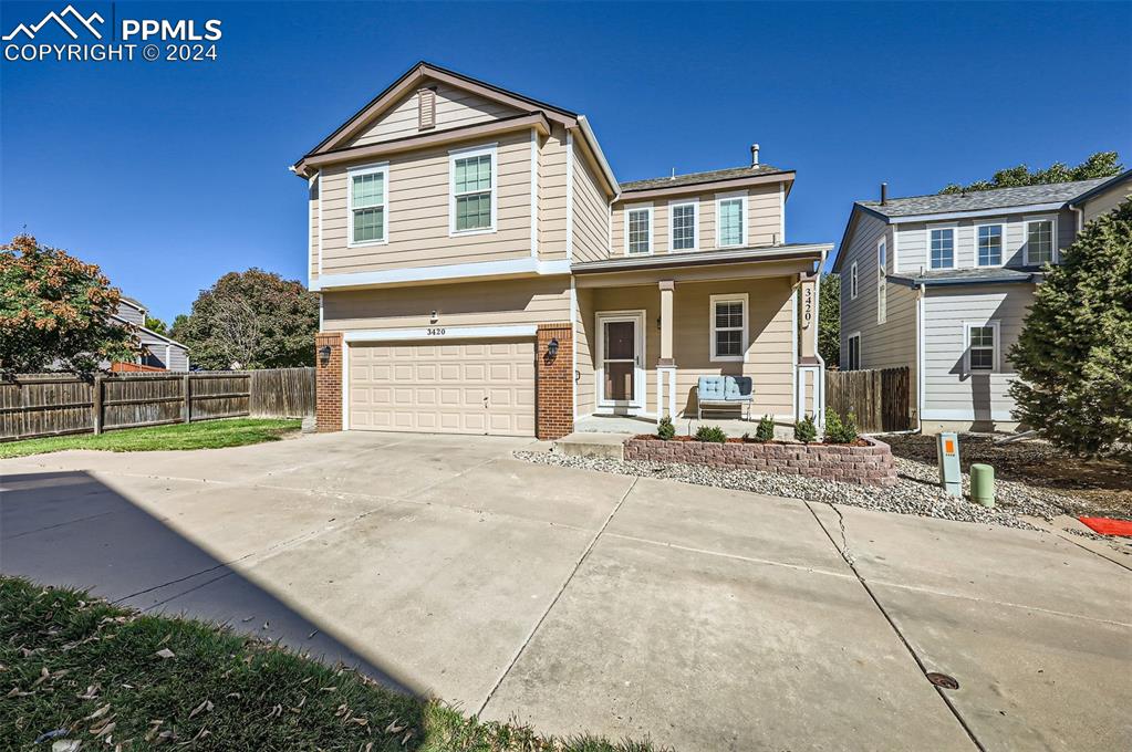 a view of a house with a yard and garage