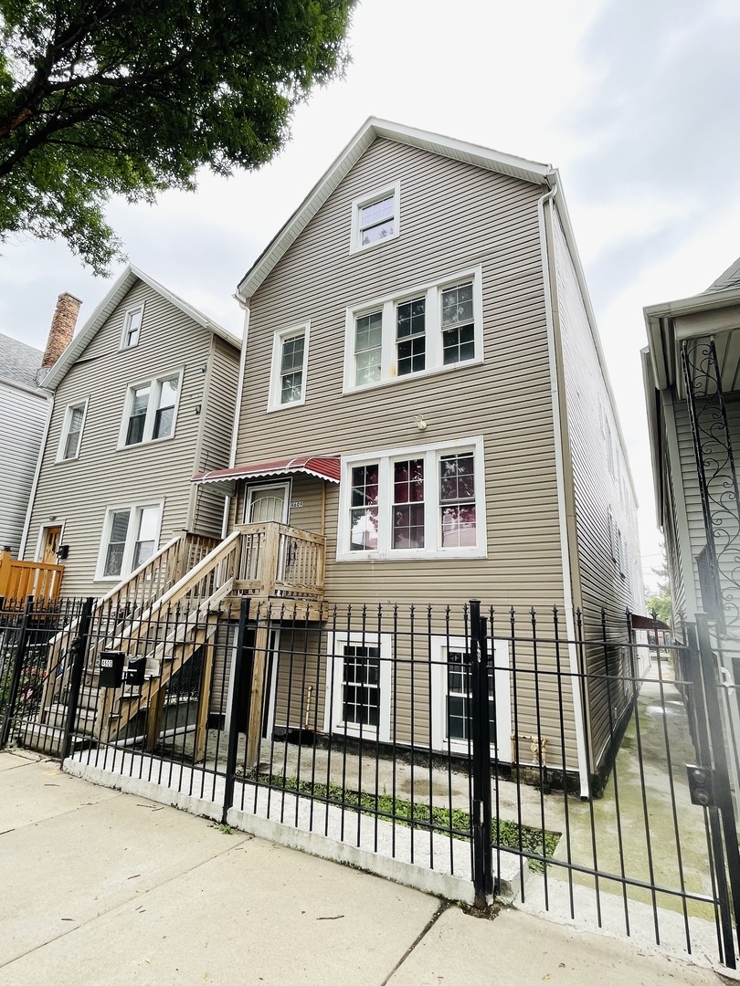 a front view of a house with a fence