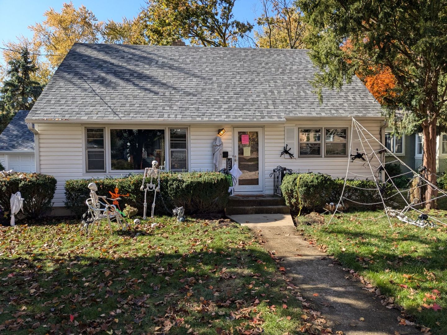 a view of a house with yard and sitting area