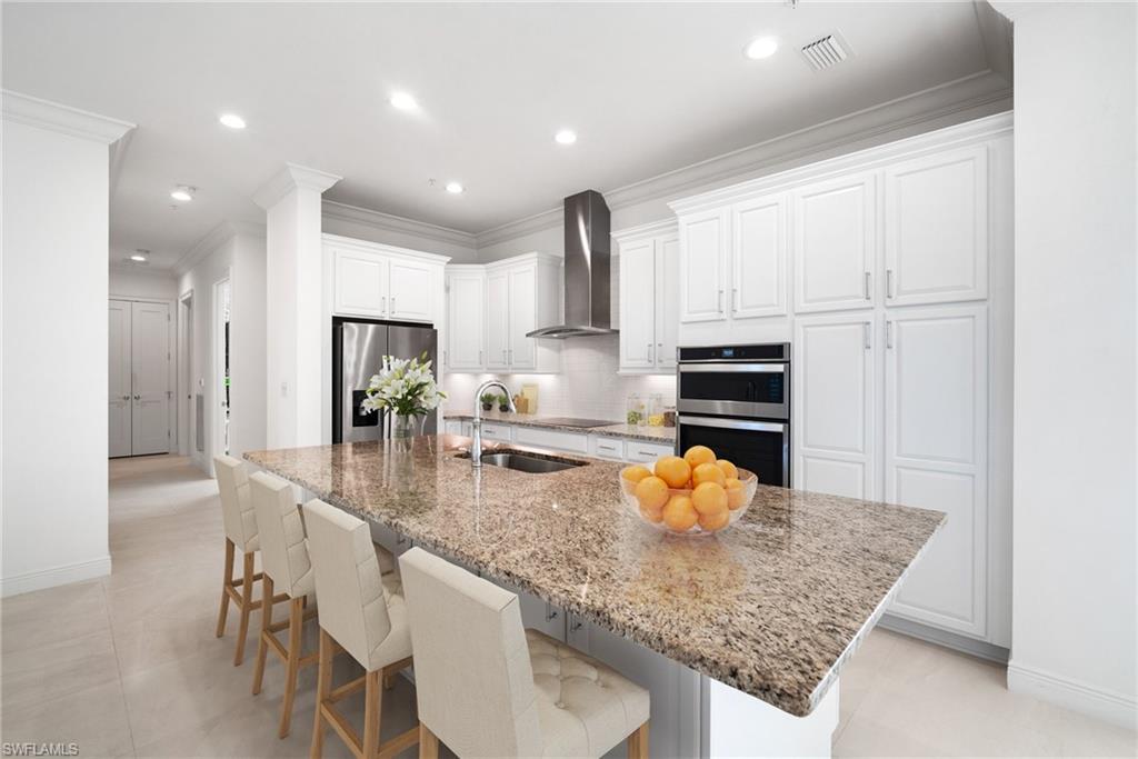 a kitchen with stainless steel appliances granite countertop a sink refrigerator and microwave