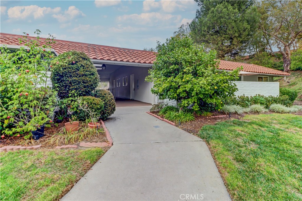 a front view of a house with a yard and trees