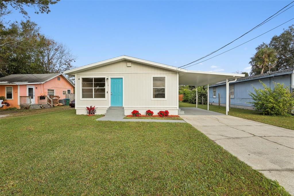 a front view of a house with a yard and trees