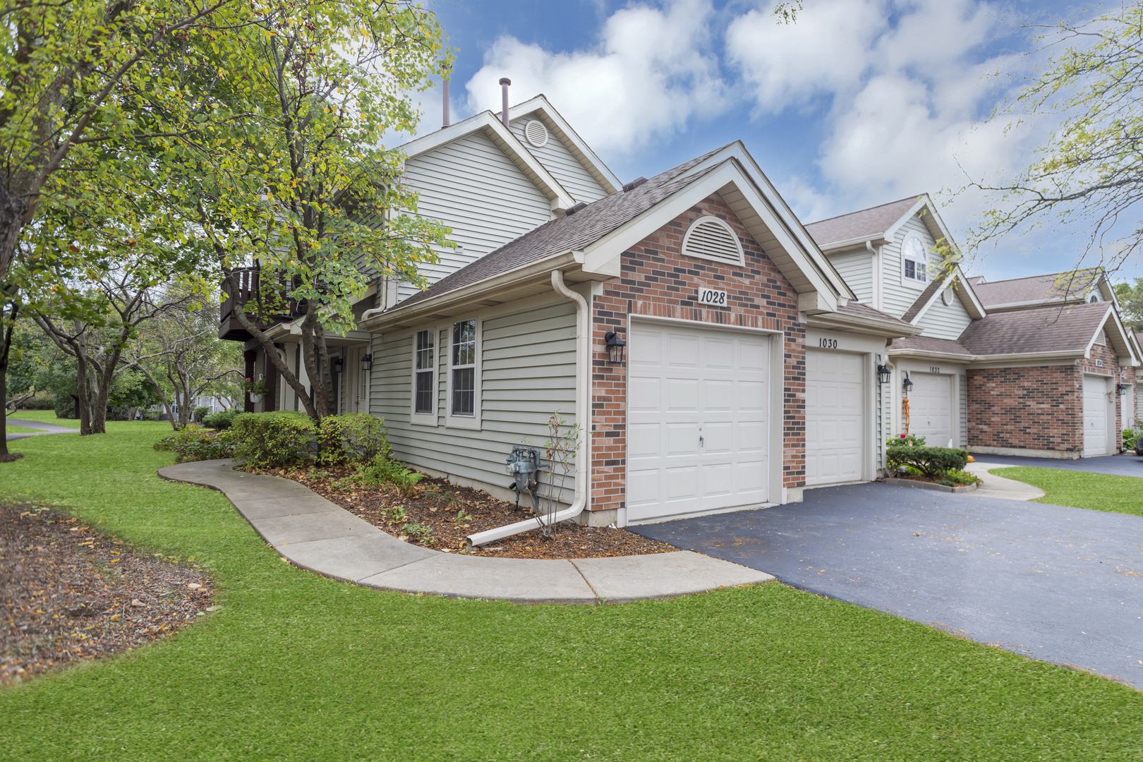 a view of a house with a yard and pathway