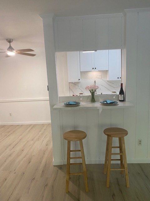 a kitchen with a sink cabinets and chair