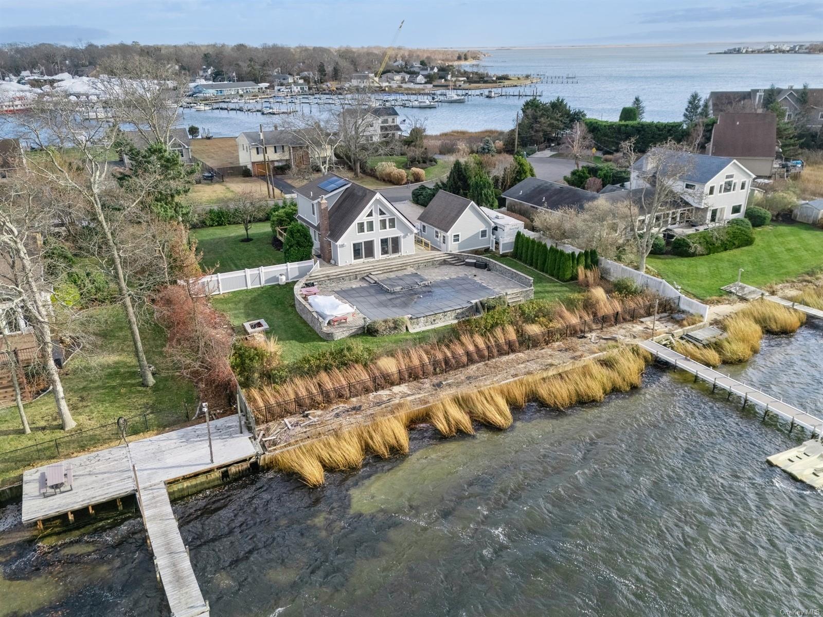 Birds eye view of property with a water view