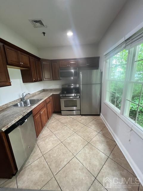 a kitchen with stainless steel appliances granite countertop a sink and a stove