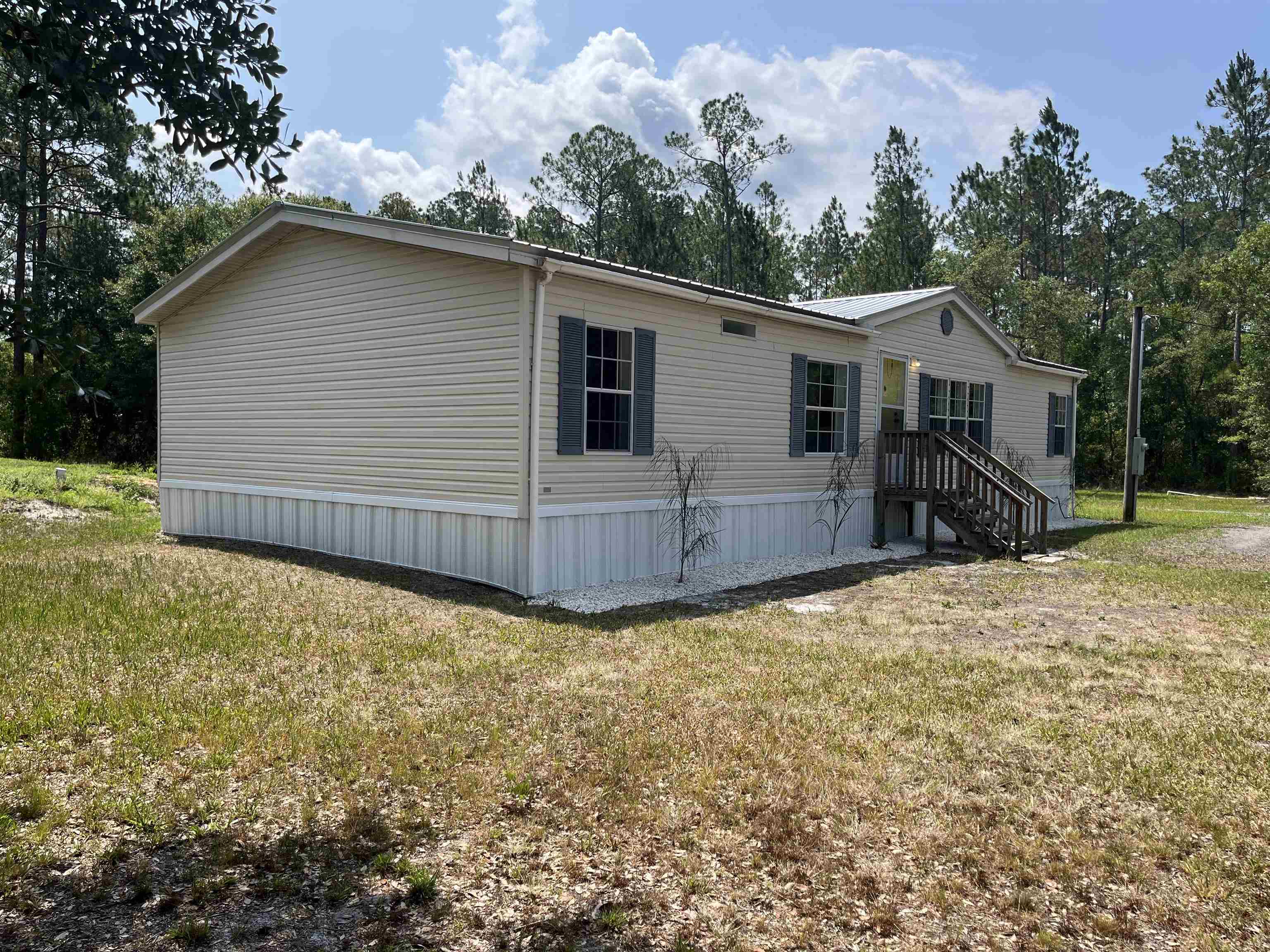 a view of a house with a yard and roof