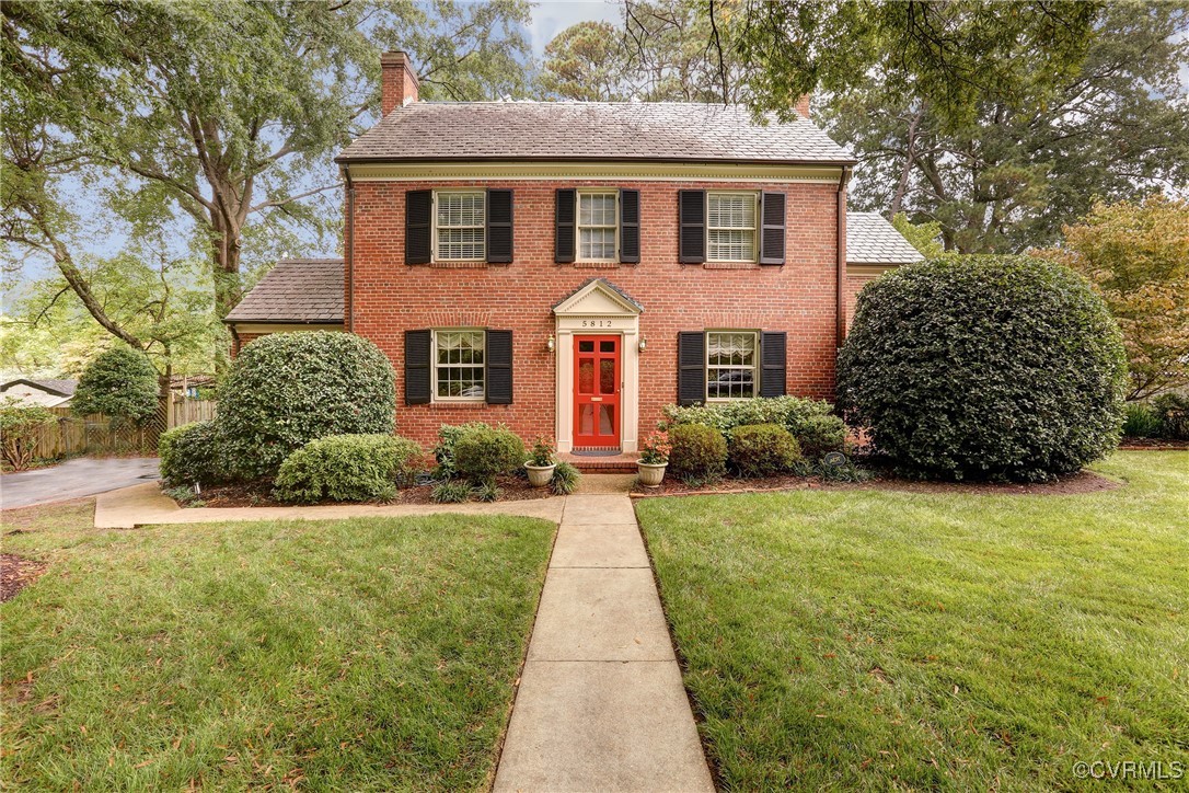 a front view of a house with a garden