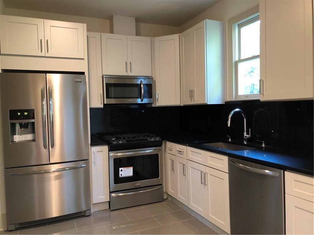 a kitchen with a refrigerator stove and microwave