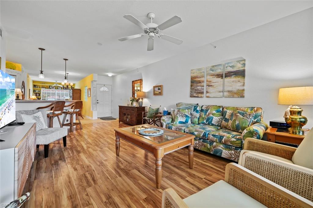 Living room featuring light wood-type flooring and ceiling fan