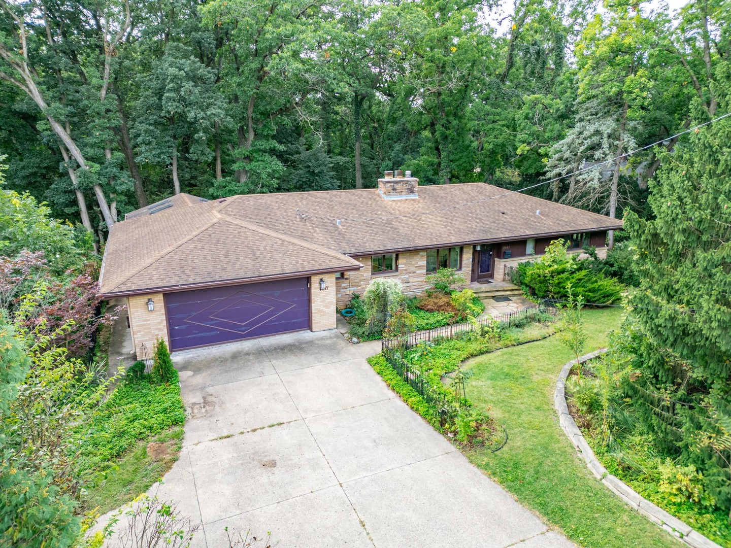 an aerial view of a house with yard and green space