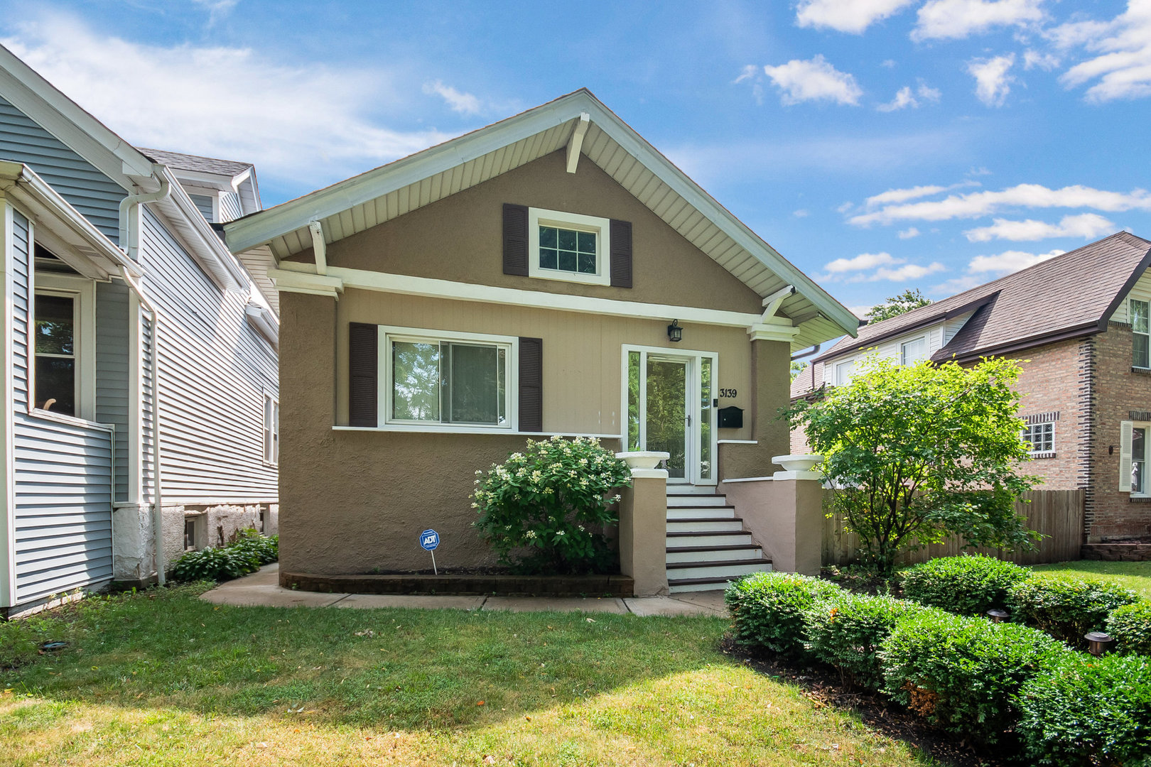 a front view of a house with a yard