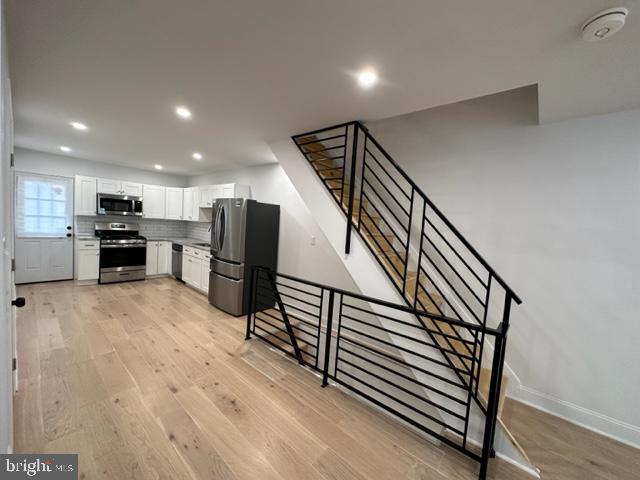 a view of kitchen with furniture and wooden floor