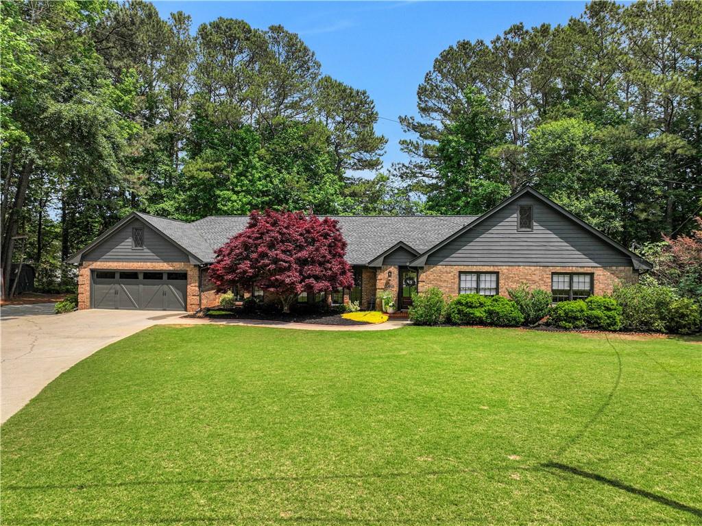 a front view of a house with yard and green space