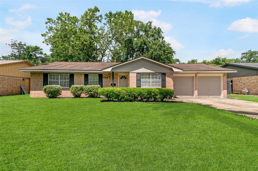 a front view of a house with a garden and plants