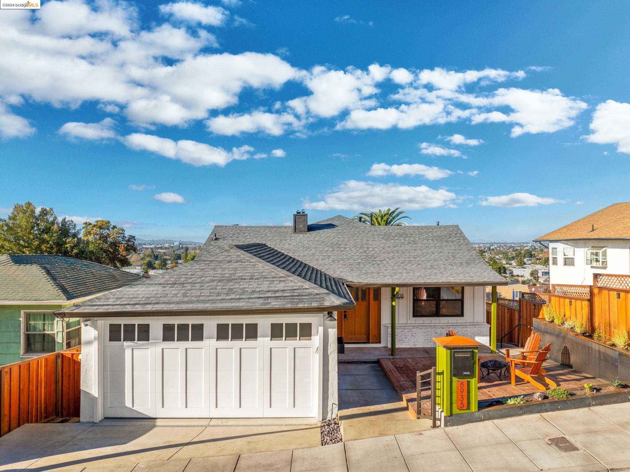 a view of a house with backyard porch and sitting area