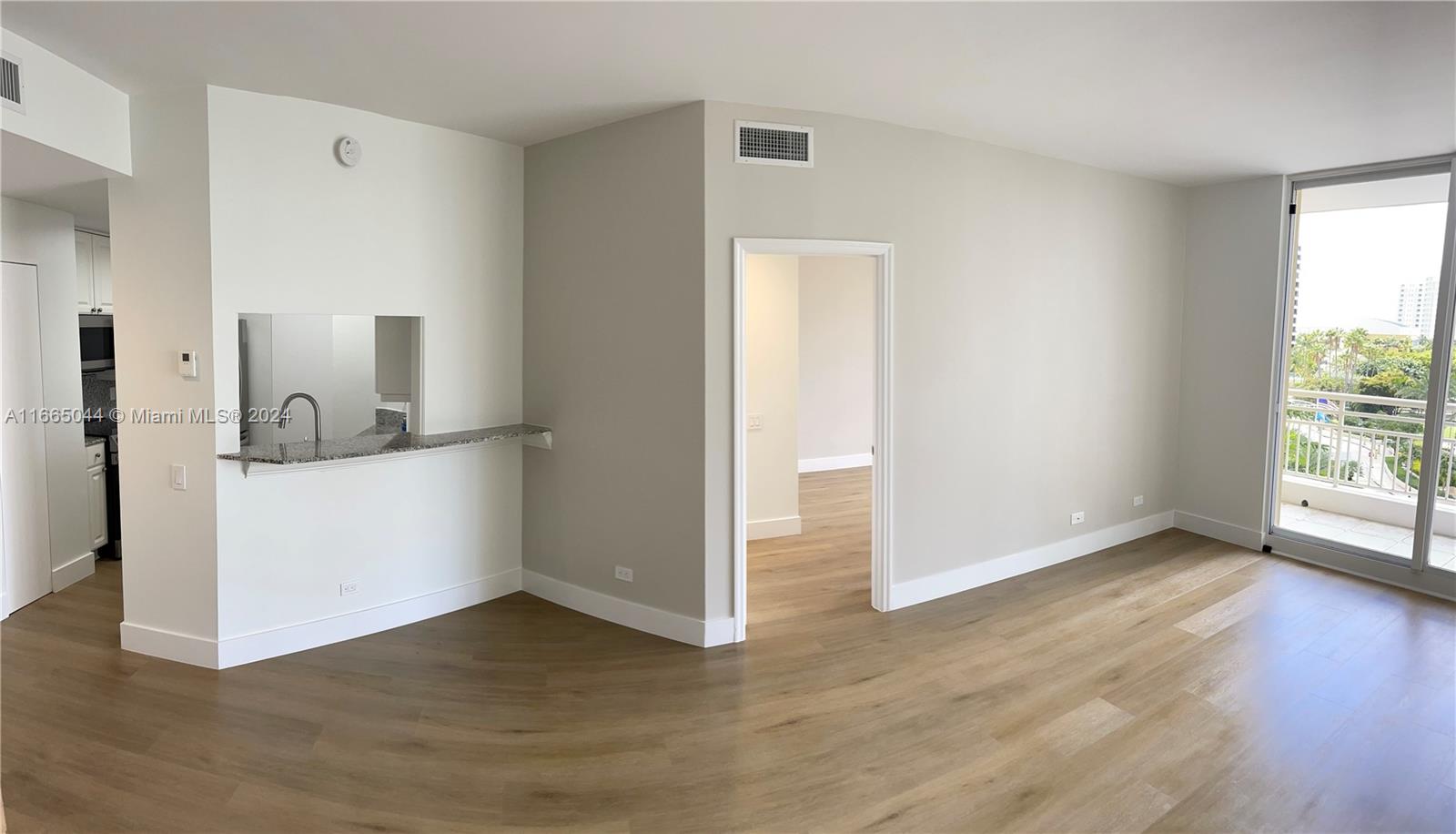 a view of a room with wooden floor and cabinet