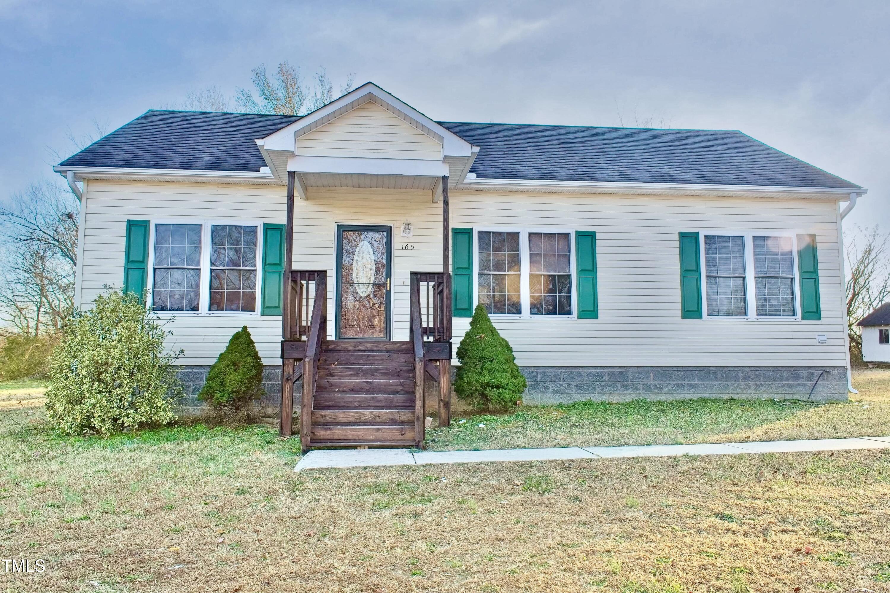 a view of a house with a yard and plants