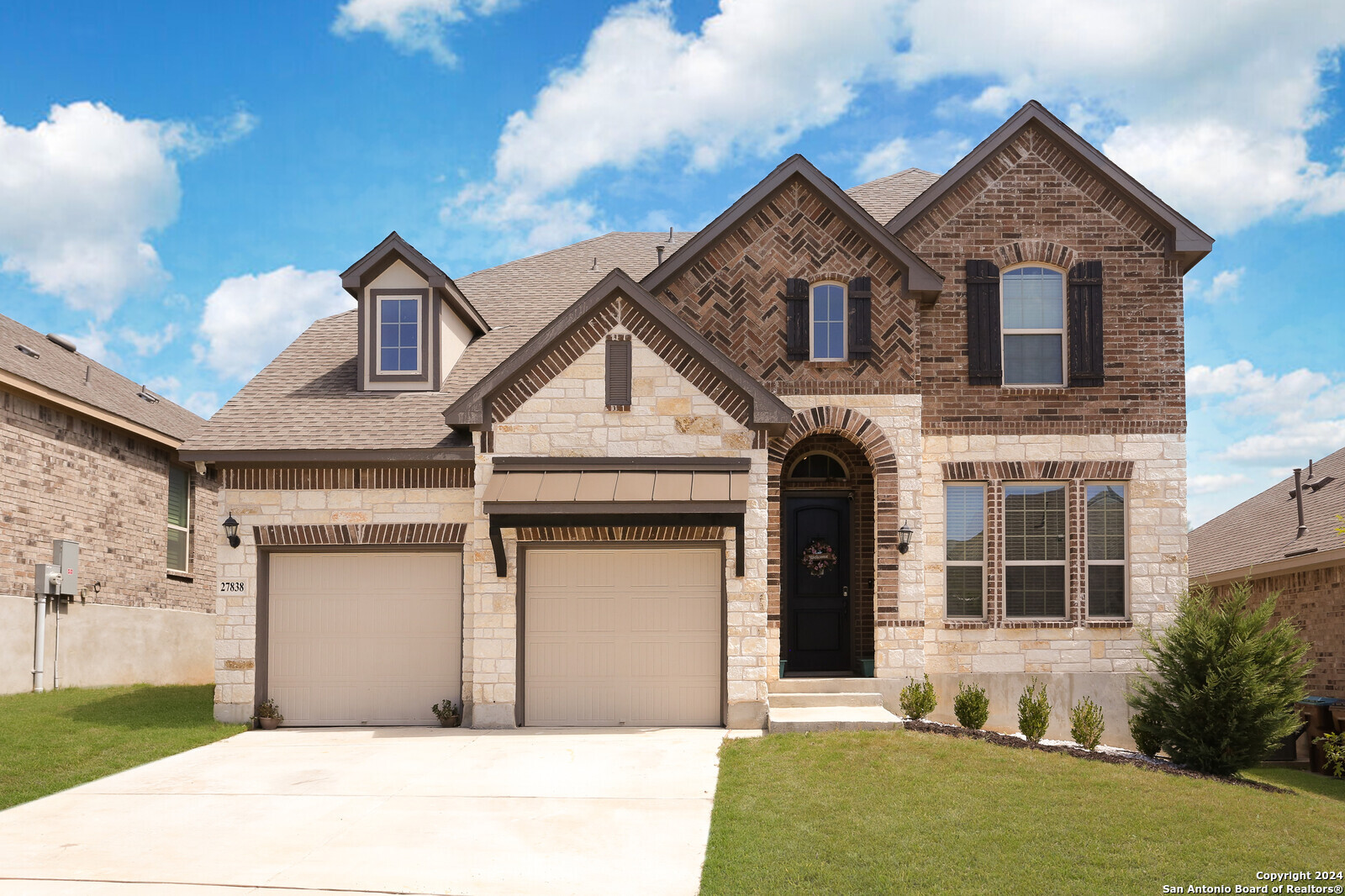 a front view of a house with garage