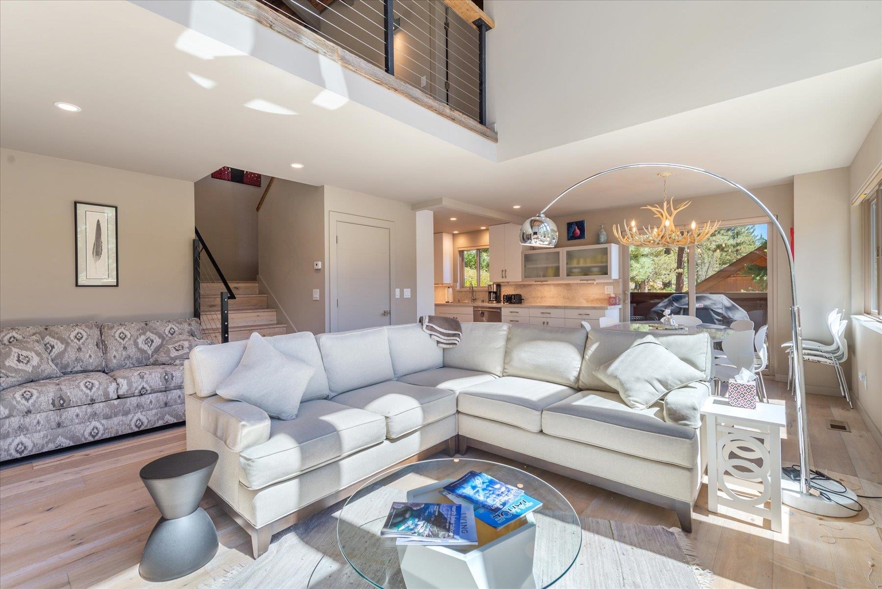 a living room with furniture a rug and white walls