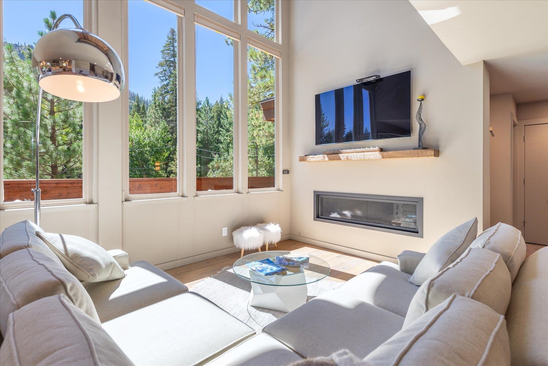 a living room with furniture a window and a fireplace