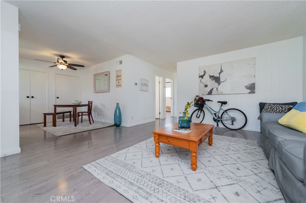 a living room with furniture a table and wooden floor