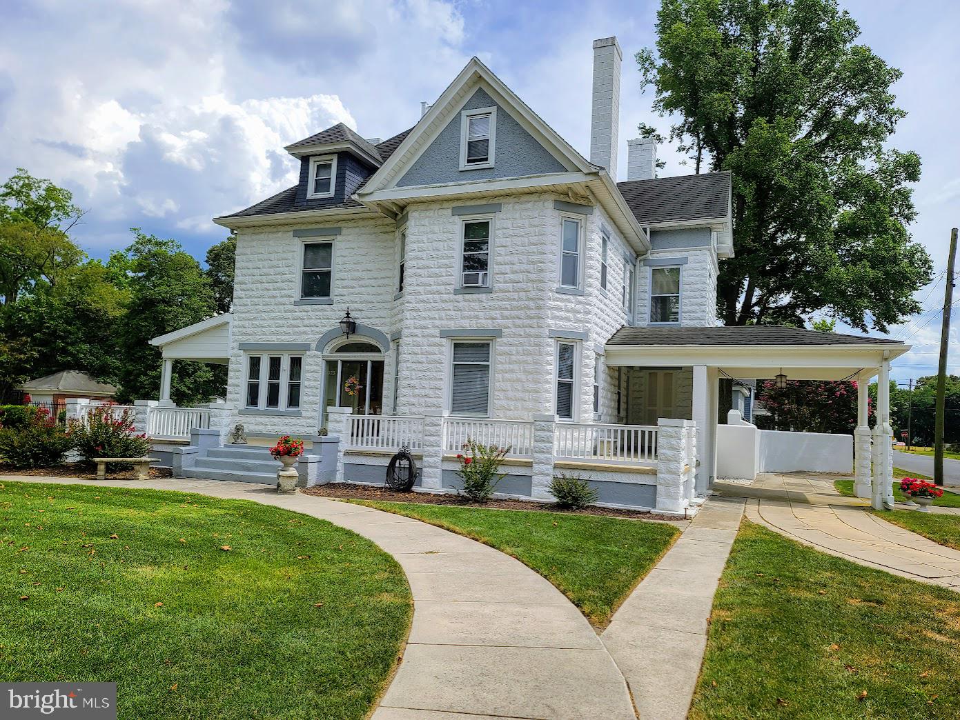 a front view of a house with a yard table and chairs