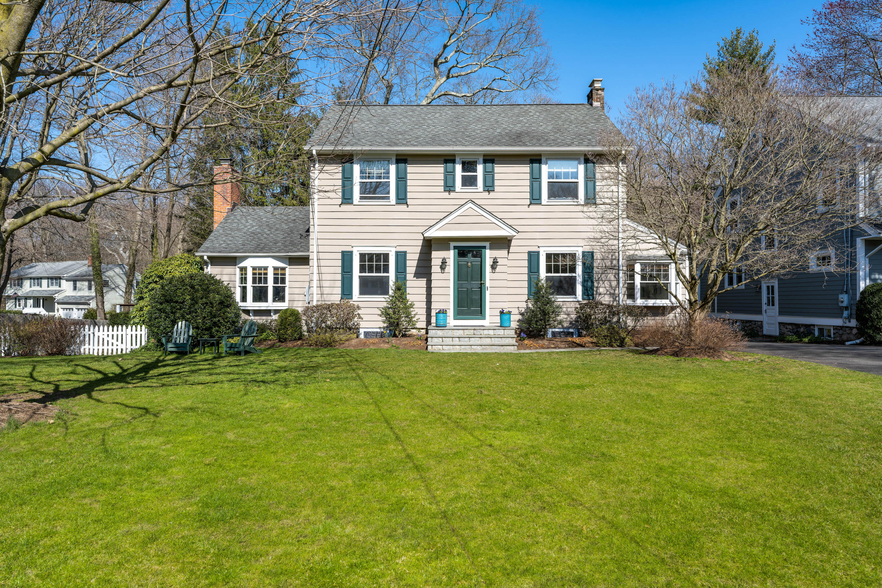 a front view of a house with a garden