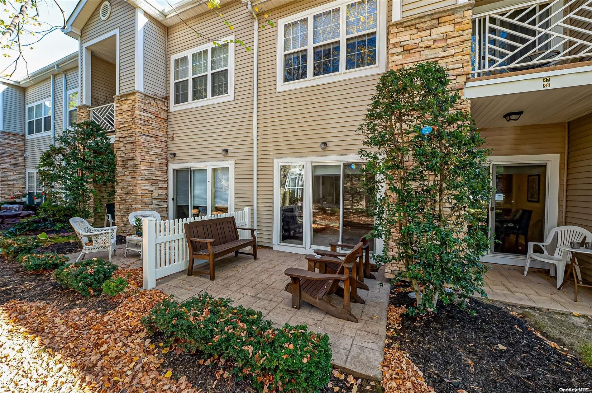 a view of a house with patio and a yard