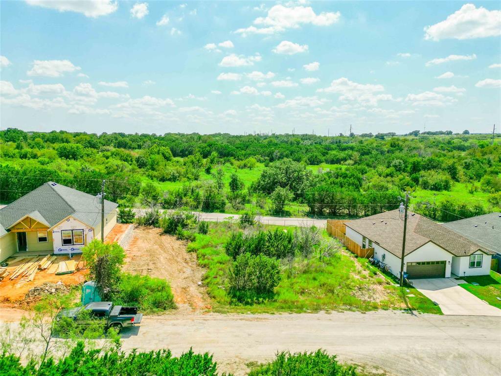 an aerial view of a house with a yard and outdoor seating