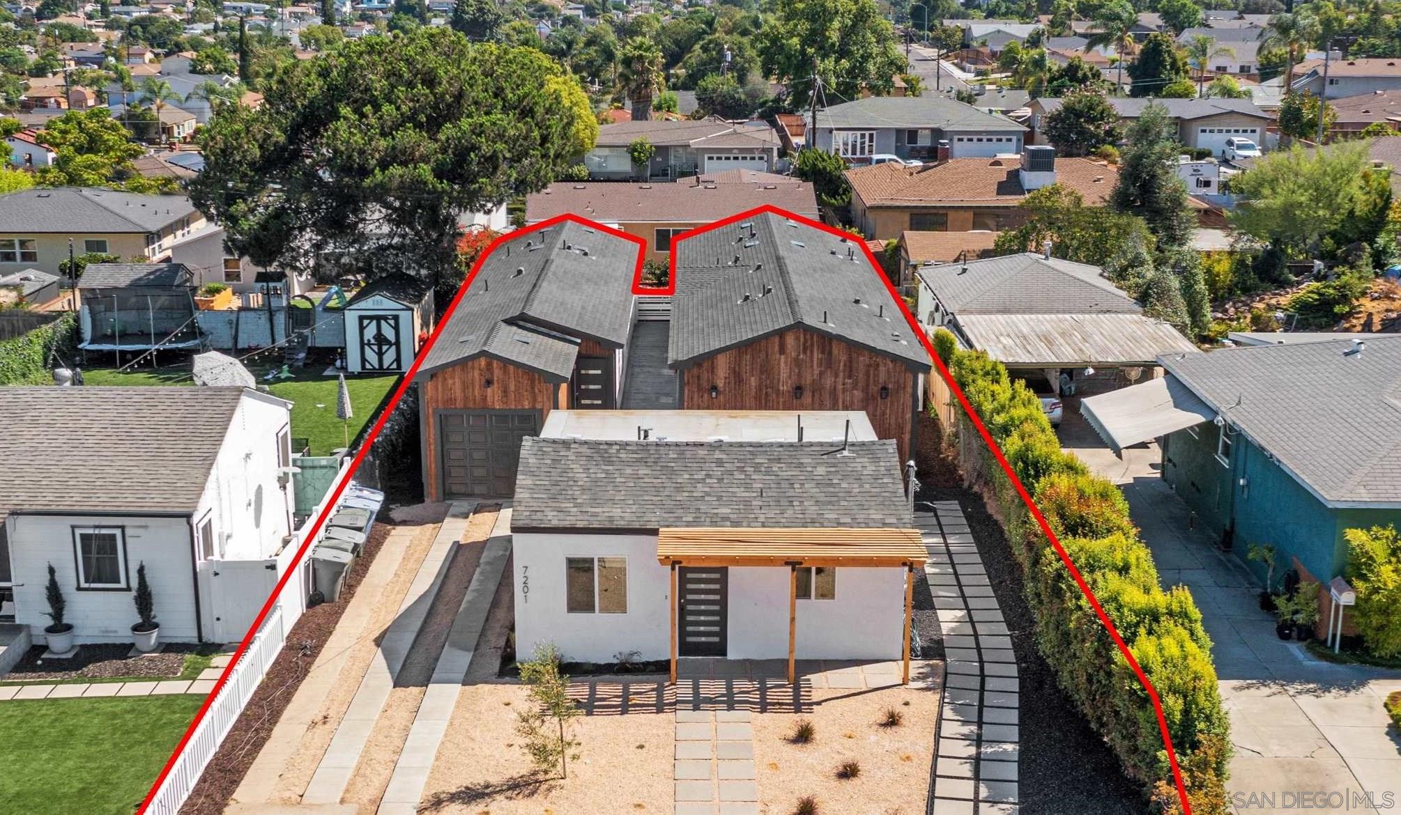 a aerial view of a house with large trees