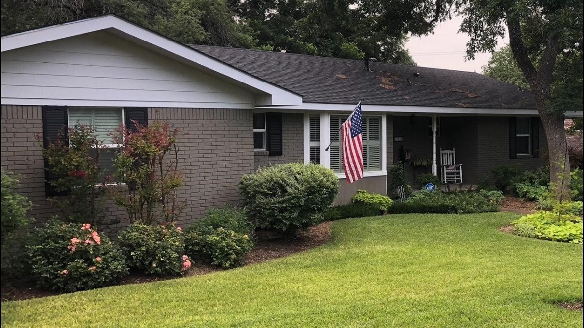 a front view of a house with garden