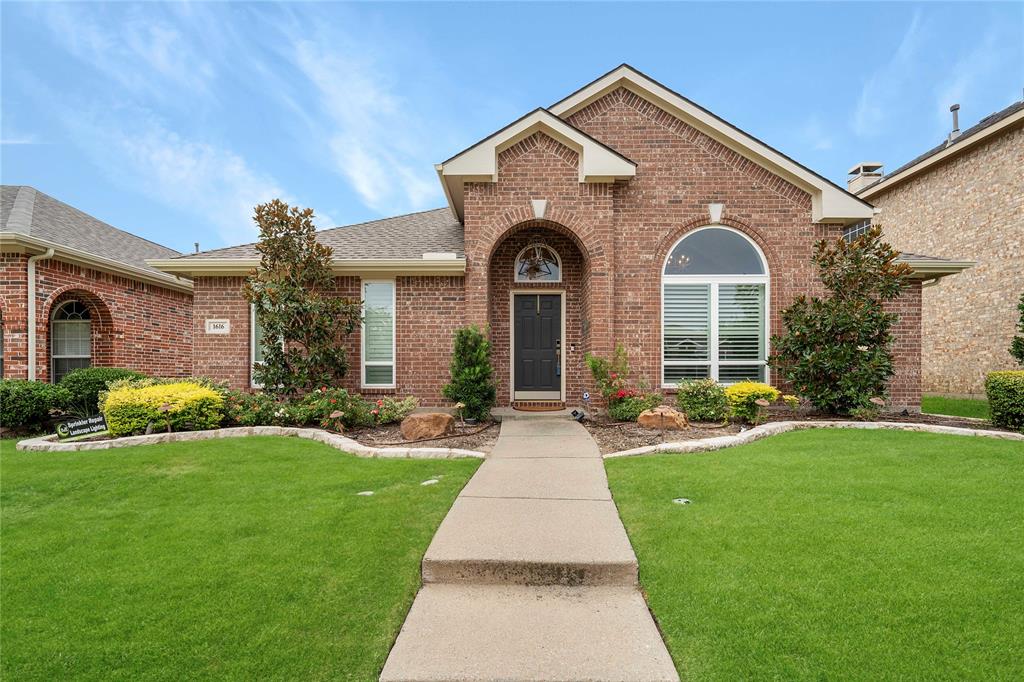 a front view of a house with yard and green space