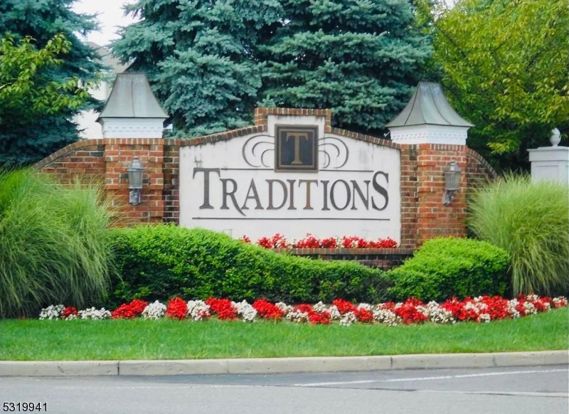 a view of sign board with flower in front of it