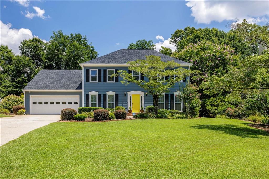 a front view of a house with garden