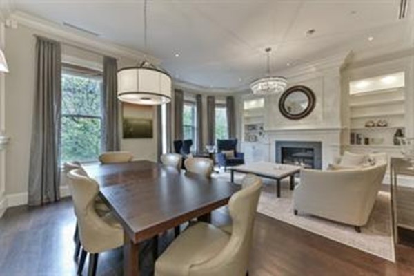 a living room with furniture a fireplace and a large window