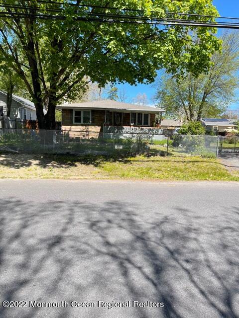 a front view of a house with a yard and a garden