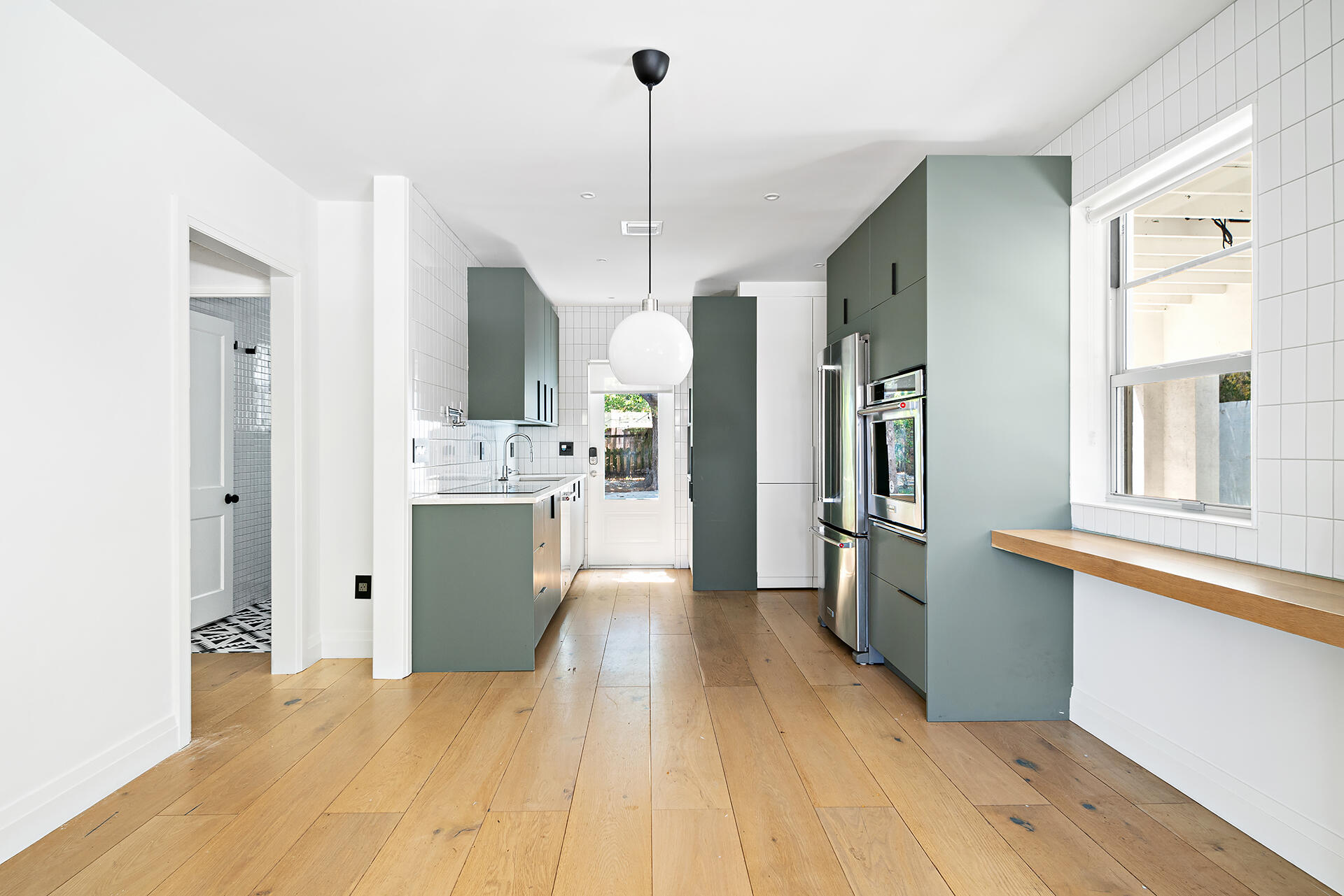 a kitchen with stainless steel appliances kitchen island a refrigerator and a sink